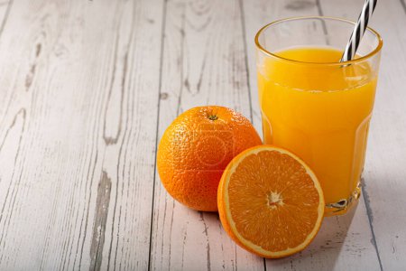 Photo for Glass with orange juice on the table. - Royalty Free Image