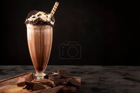 Photo for Chocolate milkshake with pieces of chocolate chip cookies. - Royalty Free Image