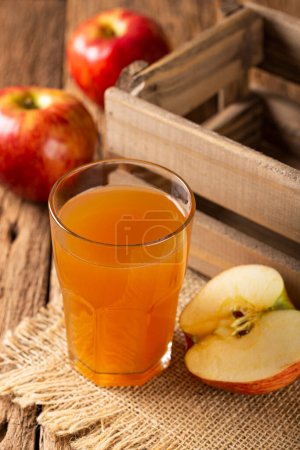 Photo for Apple juice and red apples on the table. - Royalty Free Image