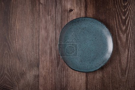 Photo for Empty plate on the wooden table. Top view of the image. - Royalty Free Image