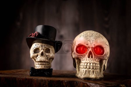 Photo for Halloween catrine skull on an old wooden table in rustic background. - Royalty Free Image