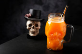Halloween drink. Pumpkin drink in skull glass. puzzle #709773196