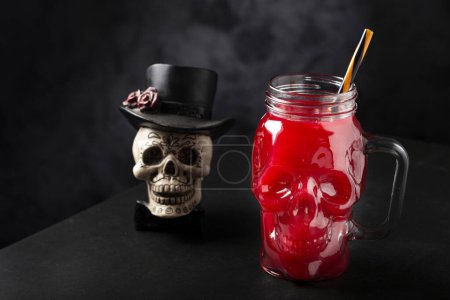 Halloween drink. Blood drink in skull glass.