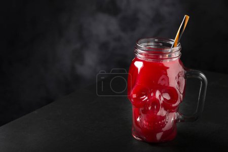 Photo for Halloween drink. Blood drink in skull glass. - Royalty Free Image