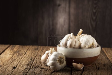 Photo for Garlic bulb and garlic cloves on the wooden table. - Royalty Free Image