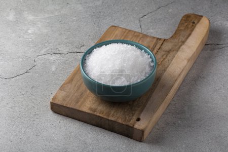 Bowl with coarse salt on the table.