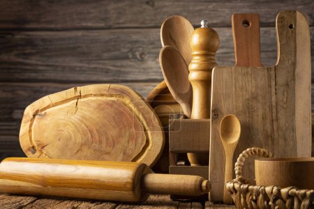 Wooden kitchen utensils on rustic background.
