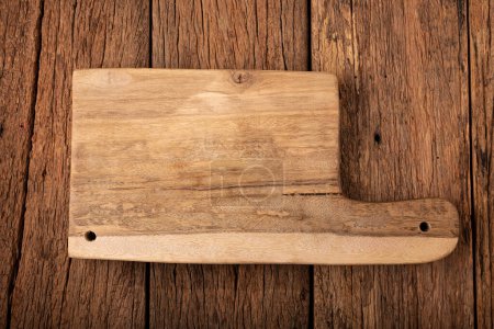 Wooden cutting board on rustic background.