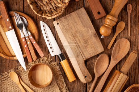 Various kitchen utensils on the rustic wooden table.
