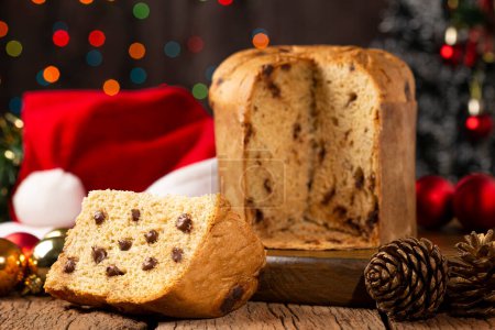 Delicious panettone with chocolate chips on a table decorated for Christmas.