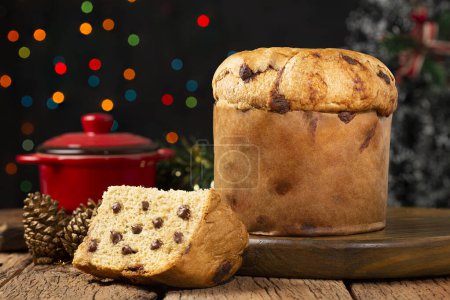 Delicious panettone with chocolate chips on a table decorated for Christmas.
