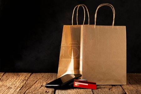 Photo for Paper bag, smartphone, wallet and credit card. Black Friday. - Royalty Free Image