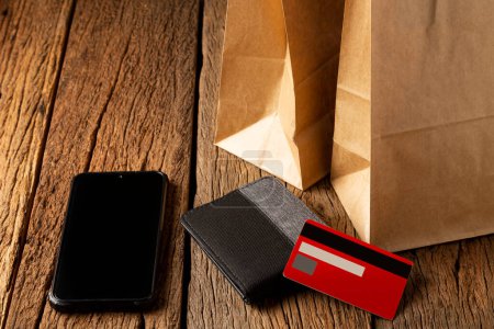 Photo for Paper bag, smartphone, wallet and credit card. Black Friday. - Royalty Free Image