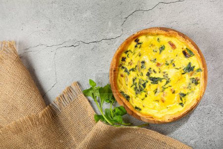 Photo for Spinach quiche with onion and bacon. - Royalty Free Image