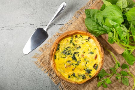 Photo for Spinach quiche with onion and bacon. - Royalty Free Image