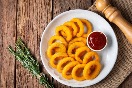 Photo for Crispy onion rings with ketchup. - Royalty Free Image