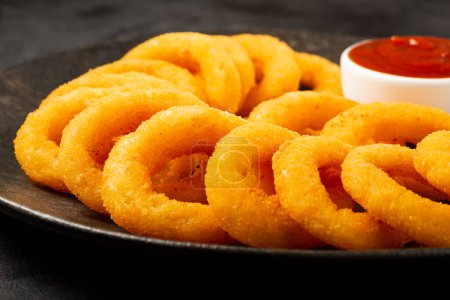 Crispy onion rings with ketchup.