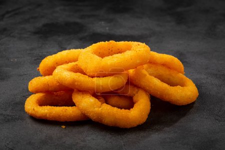 Crispy fried onion rings on the table.