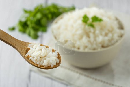 Rice cooked in wooden spoon.