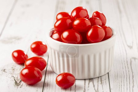 Fresh grape tomatoes in a bowl on the table.