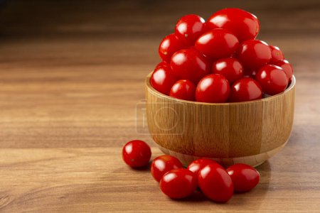 Photo for Fresh grape tomatoes in a bowl on the table. - Royalty Free Image