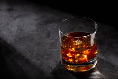 Photo for Glass with whiskey and ice cubes. - Royalty Free Image