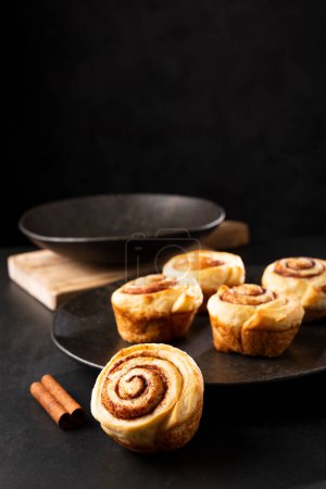 Photo for Cinnamon rolls on dark background. - Royalty Free Image