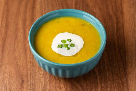 Bowl with pumpkin soup on the table.