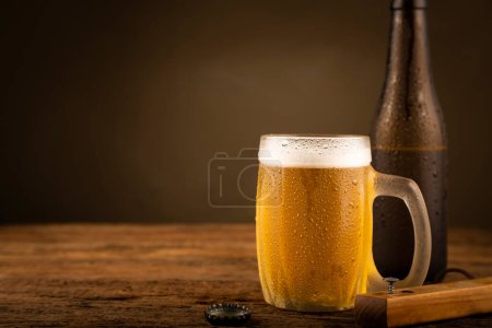 Photo for Glass full of cold beer on the wooden table - Royalty Free Image
