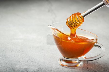 Photo for Honey in glass bowl on the table. - Royalty Free Image