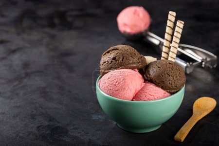 Photo for Bowl with Neapolitan ice cream on dark background. - Royalty Free Image