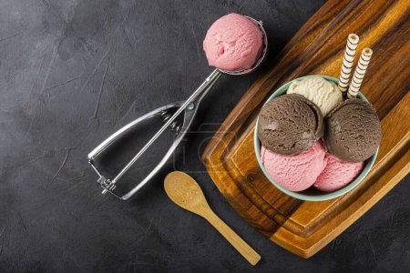 Photo for Bowl with Neapolitan ice cream on dark background. - Royalty Free Image