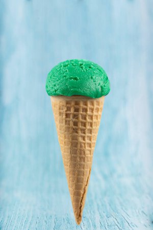 Tasty pistachio ice cream cone.
