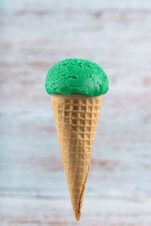 Tasty pistachio ice cream cone.