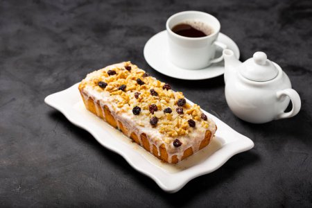 Photo for English cake topped with fondant, raisins and walnuts. - Royalty Free Image