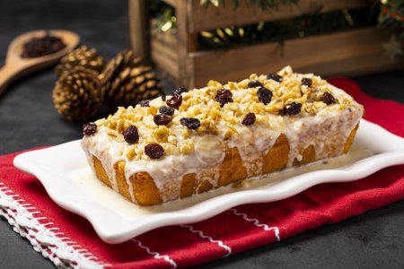 Photo for English cake topped with fondant, raisins and walnuts. - Royalty Free Image