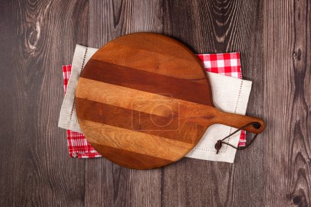 Empty pizza board on rustic wooden table. Top view image.
