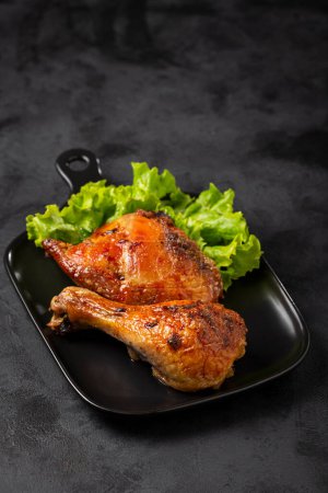 Photo for Roasted chicken pieces with lettuce salad. - Royalty Free Image