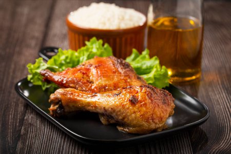 Photo for Roasted chicken pieces with lettuce salad. - Royalty Free Image