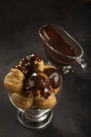 Photo for Delicious profiteroles with coffee on the table. - Royalty Free Image