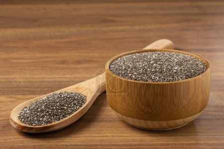 Photo for Chia seeds in wooden bowl and wooden spoon. - Royalty Free Image