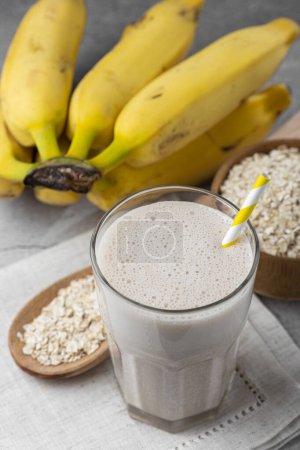 Photo for Banana smoothie with milk, banana and oatmeal. - Royalty Free Image