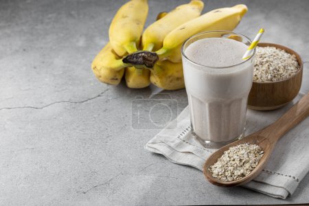 Photo for Banana smoothie with milk, banana and oatmeal. - Royalty Free Image