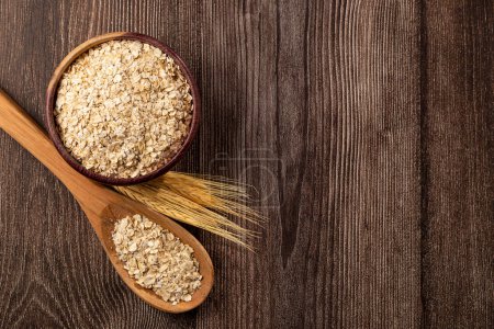Photo for Oat flakes in wooden bowl. - Royalty Free Image