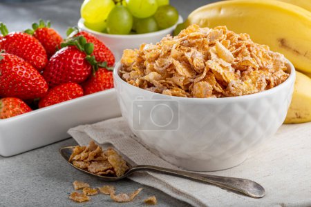 Photo for Corn flakes in the bowl with berries on the table. - Royalty Free Image