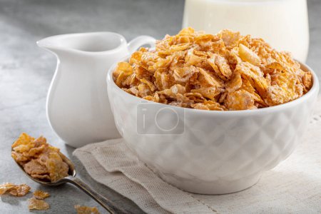 Photo for Corn flakes in bowl and glass of milk on table. - Royalty Free Image