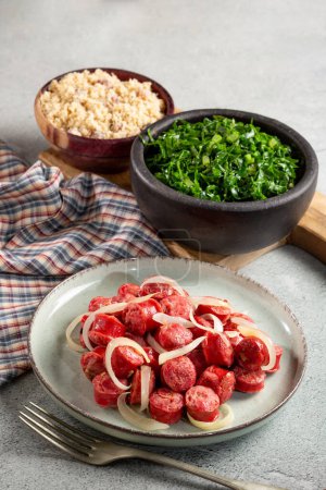 Photo for Sliced sausage with onion, green cabbage and farofa. - Royalty Free Image