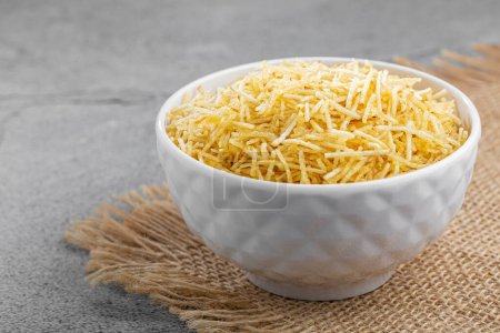 Straw potatoes in a bowl on the table.