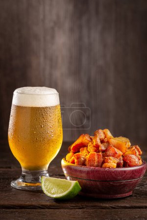 Pork rinds (torresmo) with beer, typical Brazilian food.