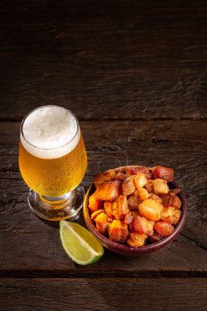 Pork rinds (torresmo) with beer, typical Brazilian food.